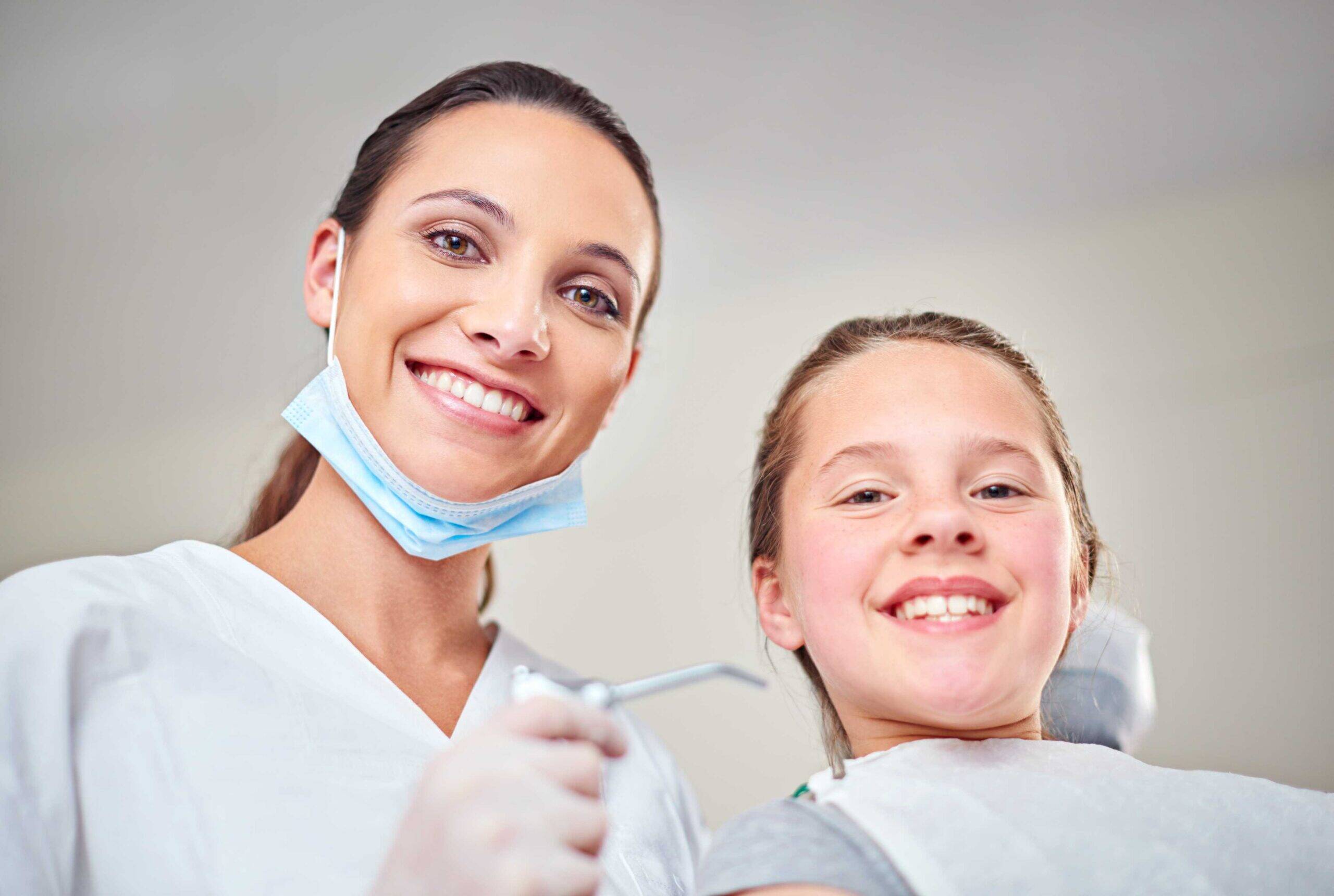 Dentist with smiling young patient.